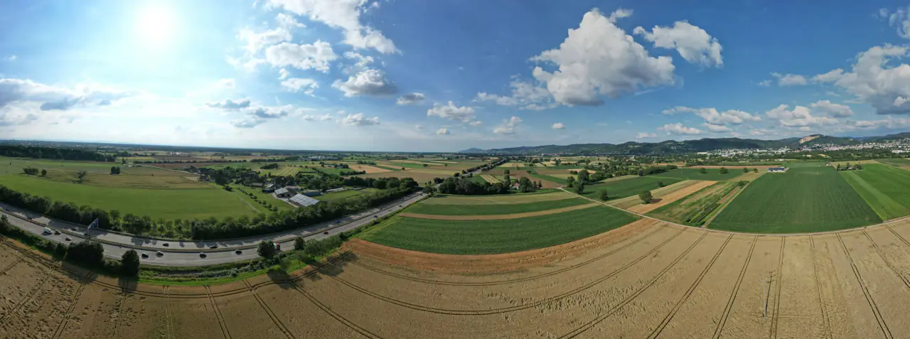Luftbild mit Feldern, Landstraße und Ortsrand